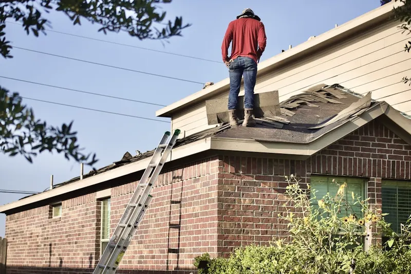 Professional roofer working on a residential roof in Miamitown